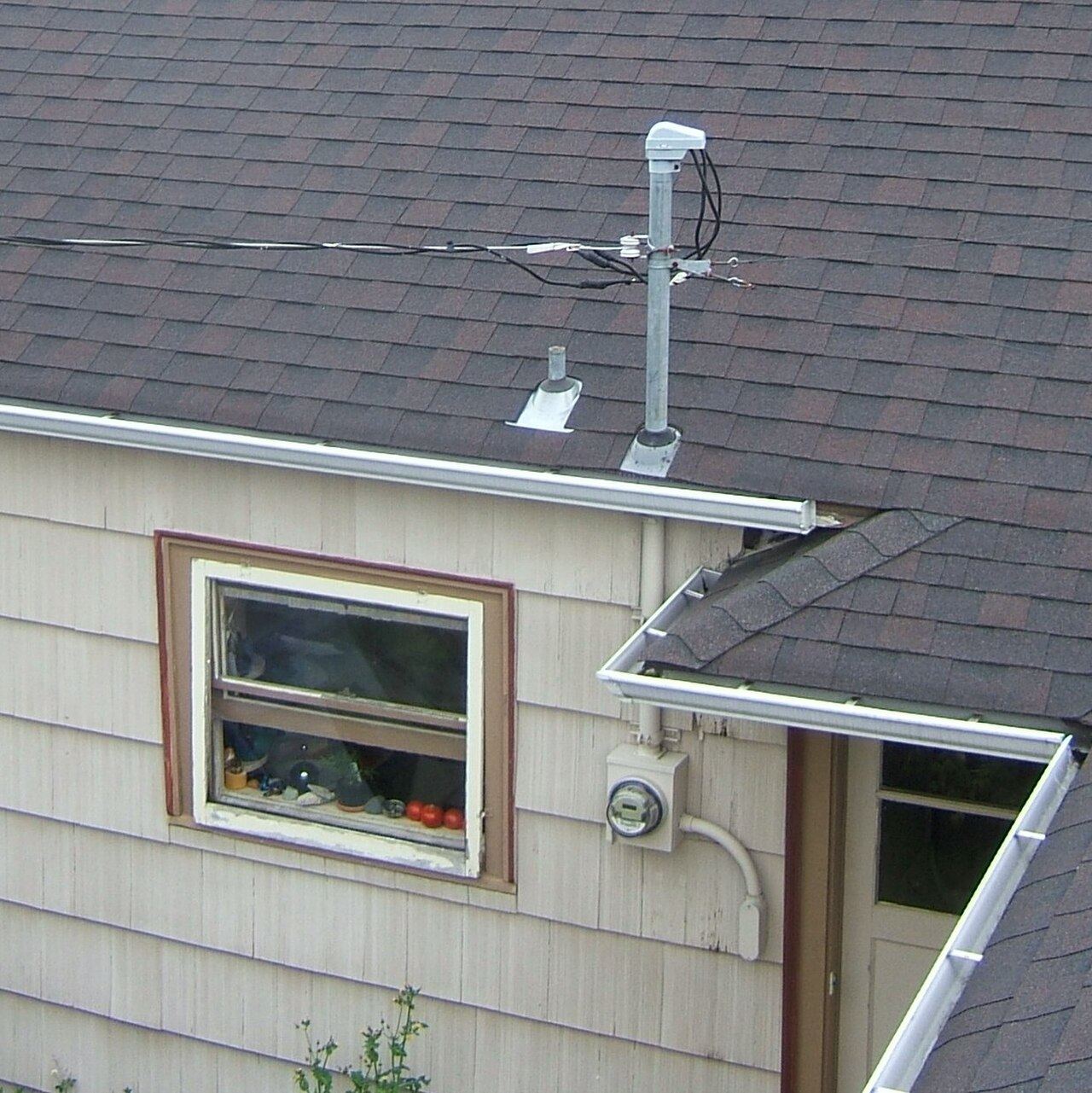 Meter and service drop on the side of a house.