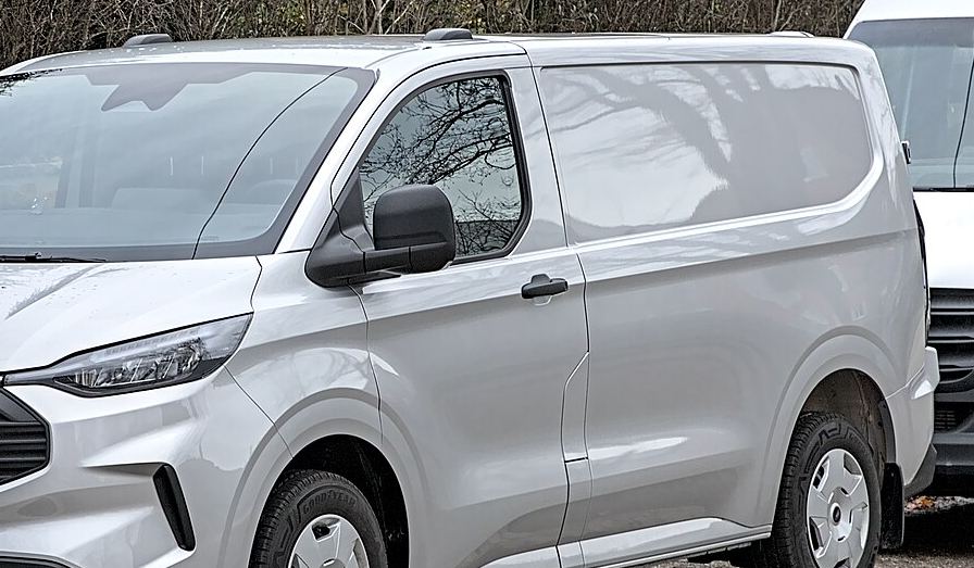 Silver cargo van used as a stand-in until the real truck is photographed.
